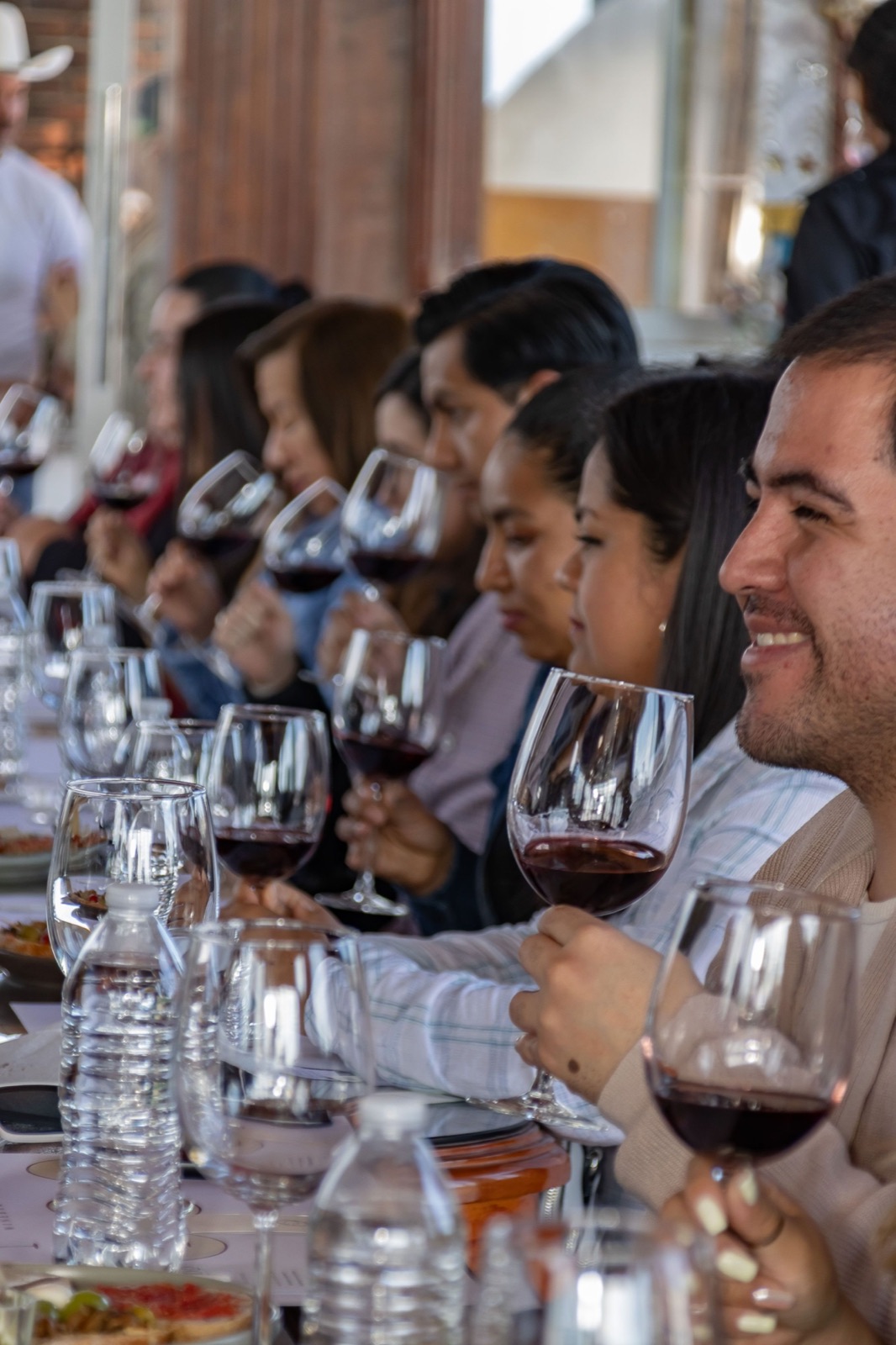 A row of people at a tasting.