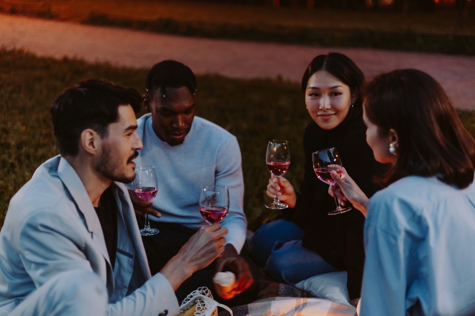 Friends raising glasses around a table.